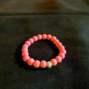 Pink stretchy bracelet, mannequin’s wrist is 6” beautiful, new, handmade